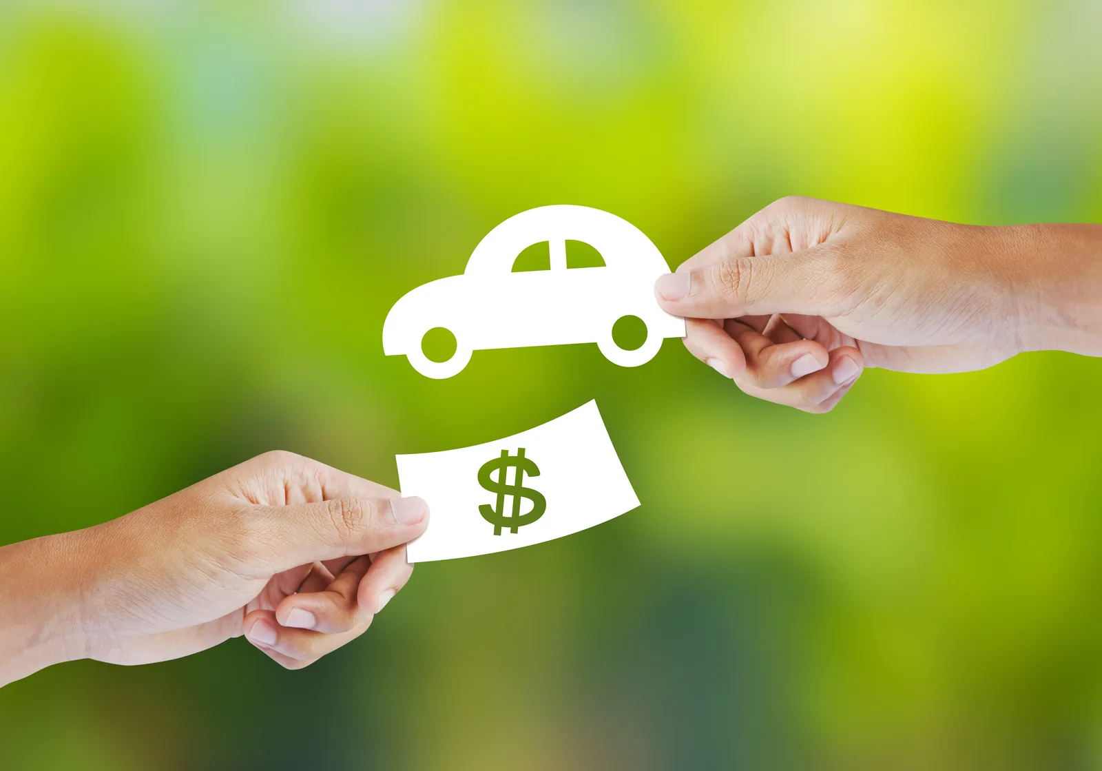 Two hands swapping a paper cut-out car for a paper note marked with a dollar sign