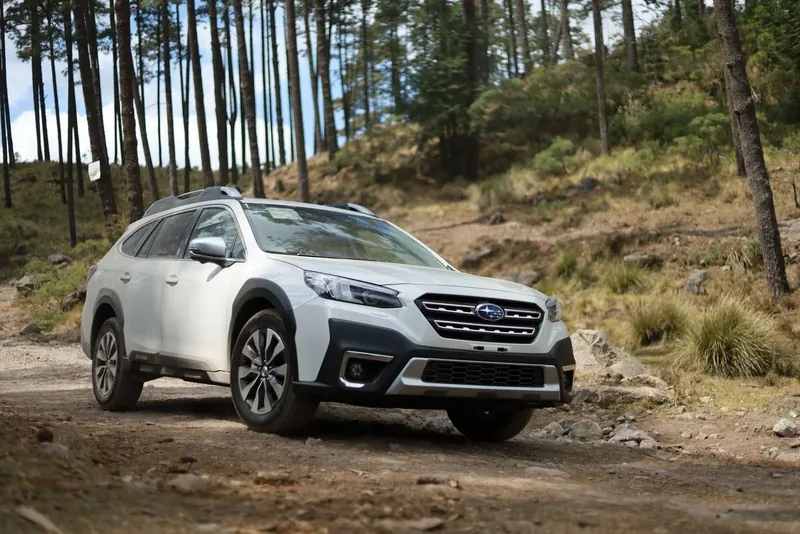 A white Subaru Outback on a forest gravel trail, a long-standing favourite for reliable all-weather driving in Australia