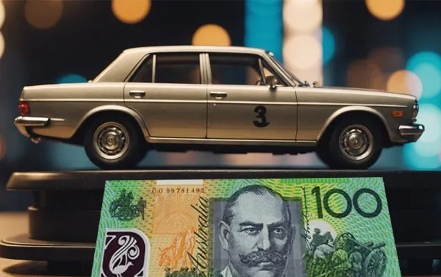 Model car parked behind an Australian one hundred dollar note