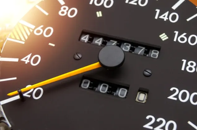 Mechanical odometer reading 447,378 on an analogue speedometer dial