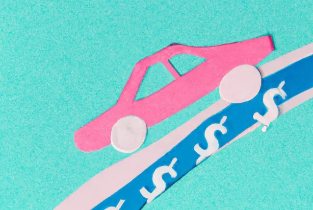 Paper cut-out car driving up a ramp made of dollar signs