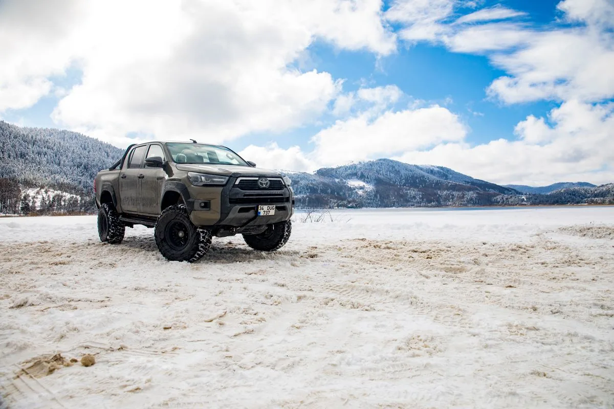 A Toyota HiLux dual-cab ute parked in rugged terrain